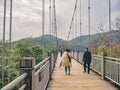 Unacquainted tourist walking on Suspension bridge cross the mountain at tianmen mountain Zhangjiajie china.