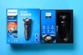 Top view box of brand new electric shaver on a blue background