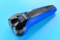 Electric shaver on a blue background