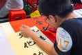 students in calligraphy competition using Chinese brushes at horizontal composition