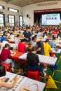 students in calligraphy competition using Chinese brushes at vertical composition