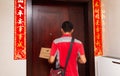 Male courier from JD.com delivering a parcel to the customers home