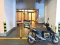 motobike with Meituan food delivery case in the park of a residential quarters at night