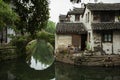 ZHOUZHUANG, CHINA: Old houses and bridge reflection in a village canal