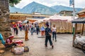 Zhoucheng village market place view with Bai minority people in traditional dress and Cangshan mountain in background in Dali