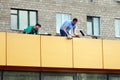 Zhukovskiy, Russia - May 02, 2017: Editorial use only. Repair workers on the roof of a store in an apartment building.