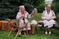 Zhytomyr, Ukraine - July 30, 2021: Elderly women weavers at the loom. Spice on an old spinning wheel Royalty Free Stock Photo