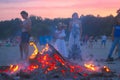 Zhytomyr, Ukraine - July 12, 2016: People celebrating in evening at the beach around fire Royalty Free Stock Photo