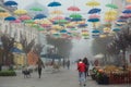 Zhytomyr, Ukraine - May 25, 2021: colored umbrellas with people at foggy street