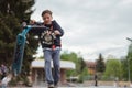 Zhytomyr, Ukraine - May 15, 2021: Teenager did unsuccessful trick on sportive push scooter on a city sports ground