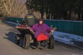 Zhytomyr, Ukraine - October 03, 2015: senior woman sitting on old horse drawn