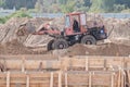 Zhytomyr, Ukraine - October 5, 2020: Wheel loader machine unloading soil during earthmoving works at construction site