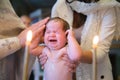 Zhytomyr, Ukraine - September 12, 2021: Newborn baby baptism in Holy water. Royalty Free Stock Photo