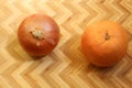 Onion and Orange on bamboo cutting board, zig-zag background Royalty Free Stock Photo