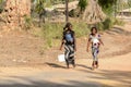 Unidentified Senegalese women walk along the road.