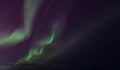 Zigzag green flashes in sky above black horizon northern lights Royalty Free Stock Photo