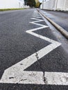 Zigzag road marking on asphalt, a visual guide for drivers Royalty Free Stock Photo