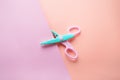 Zigzag scissors top view on pink and peach background