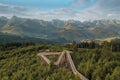 Zigzag wooden path in the forest against the Swiss Alps background Royalty Free Stock Photo