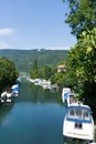 The Zihl canal with anchored boats on the shores of Lake Biel Royalty Free Stock Photo