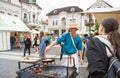 Zilina, Slovak RepubliÃÂ, Slovakia - July 28, 2023: Man preparing natural flatbread on fire during traditional annual medieval