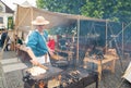 Zilina, Slovak RepubliÃÂ, Slovakia - July 28, 2023: Man preparing natural flatbread on fire during traditional annual medieval