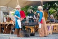 Zilina, Slovak RepubliÃÂ, Slovakia - July 28, 2023: Man woman preparing natural flatbread on fire during traditional annual