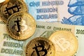 Zimbabwe hyperinflation banknotes and Bitcoin Cryptocurrency coins