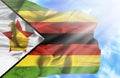 Zimbabwe waving flag against blue sky with sunrays Royalty Free Stock Photo