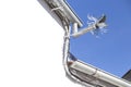 Zinc gutter drainage system dragon-shaped over blue sky