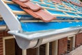 Zinc gutter and tiles on roof pitch of house