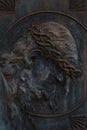 Zinc metal bas relief sculpture of a suffering Jesus Christ on a grave