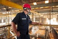 Zinc mine. Back view of confident engineer looking at the factory mining and thinking.