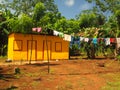 Zinc sheet metal house in jungle with laundry drying Quinn Hill