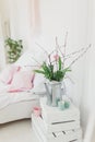 Zinc watering can with pink tulips over white background in bedroom Royalty Free Stock Photo