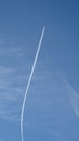 In zinita, the silhouette of an airplane is visible, leaving a white trail in the blue sky.
