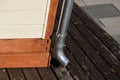 Zink pipe downspout. rain water leader attached to wood tool shed
