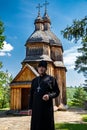 Zinkiv. Ukraine.17 July 2020. A priest and an old wooden church in the Ukrainian village