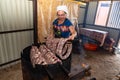 Zinkov. Ukraine. June 17, 2020. A woman makes a traditional homemade sausage