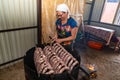 Zinkov. Ukraine. June 17, 2020. A woman makes a traditional homemade sausage