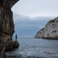Zinzulusa Caves, near Castro on the Salento Peninsula in Puglia, Italy. Person stands on gang plank at entrance to the caves.