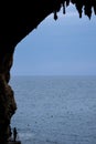 Zinzulusa Caves, near Castro on the Salento Peninsula in Puglia, Italy. Person stands on gang plank at entrance to the caves.