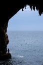 Zinzulusa Caves, near Castro on the Salento Peninsula in Puglia, Italy. Person stands on gang plank at entrance to the caves.