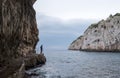 Zinzulusa Caves, near Castro on the Salento Peninsula in Puglia, Italy. Person stands on gang plank at entrance to the caves.