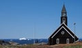 Zion\'s Church on the shore in front of the sea with ice from the icebergs, Ilulissat, Greenland