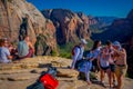 ZION, UTAH, USA - JUNE 14, 2018: Outdoor beautiful view of young hikers looking at view in Zion National park. People