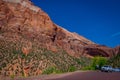 ZION, UTAH, USA - JUNE 12, 2018: Unidentified man taking pictures from the asphalt to the picturesque mountains of