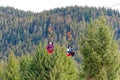 Zip Line Riders in Icy Strait Royalty Free Stock Photo