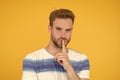 Zip your lip. Trying to keep it a secret. Secret spy or agent with silence gesture on yellow background. Handsome man Royalty Free Stock Photo