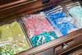 ziplock bags of sequins and beads in drawer